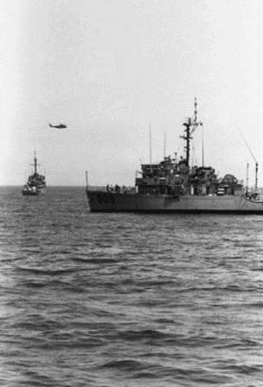 USS Adroit (MSO-509) in the foreground during
      post-ceasefire mine clearance operations.